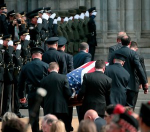 Pallbearers carry the casket of North County Cooperative Officer Michael Langsdorf inside the Cathedral Basilica of St. Louis for his funeral Mass on Monday, July 1, 2019.