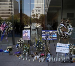 A memorial for slain police officer Juan Diaz is placed outside of Los Angeles Police Department headquarters Tuesday, Aug. 6, 2019, in Los Angeles. (AP Photo/Marcio Jose Sanchez)