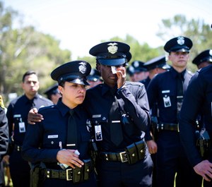 Los Angeles Police Department officers mourn during the funeral of fellow Officer Juan Jose Diaz at Forest Lawn Hollywood Hills cemetery, Monday, Aug. 12, 2019, in Los Angeles. (Sarah Reingewirtz/The Orange County Register via AP)