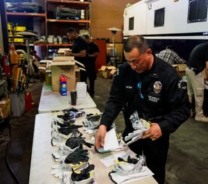 Los Angeles police Lt. Jay Hom helps assemble kits consisting of an N95 mask, work gloves and nitrile gloves on March 11 for field officers to protect themselves from the coronavirus.