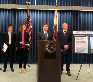 California Attorney General Xavier Becerra, second from right, announces an independent review of the Los Angeles Police Department's use of a gang member database after allegations of misuse on Monday, Feb. 10.