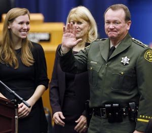 Los Angeles County Sheriff Jim McDonnell right, with his wife, Kathy, middle, and his daughter, Megan, left, is sworn in as head of the Los Angeles County Sheriff’s Department downtown Los Angeles, Monday, Dec. 1, 2014.