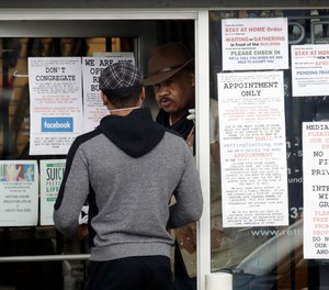 An employee answers questions at the entrance to a gun shop in Culver City, Calif. Los Angeles County Sheriff Alex Villanueva said he would like to see gun shops shut down.
