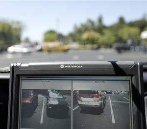 A police vehicle driven by San Diego County Deputy Sheriff Ben Chassen reads the license plates of cars in a parking lot Wednesday, Sept. 17, 2014, in San Marcos, Calif.