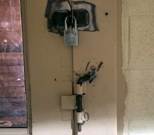 This undated photo provided by the Arizona Department of Corrections shows a cell door in Arizona State Prison Complex-Lewis prison in Buckeye, Ariz., with an added pin and padlock to keep inmates from opening it when locked. (Arizona Department of Corrections via AP, File)