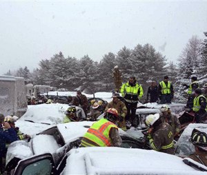 In this photo provided by Maine State Police And Maine Emergency Management, emergency personnel respond to a multi vehicle pileup on Interstate 95 near Bangor, Maine, Wednesday, Feb. 25, 2015. State police spokesman Steve McCausland says the pileup in Etna happened early Wednesday in heavy snow and involved many cars, a school bus and a tractor trailer. No fatalities were immediately reported but McCausland says some of the injuries were serious. (AP Photo/Maine State Police And Maine Emergency Management, Stephen McCausland)
