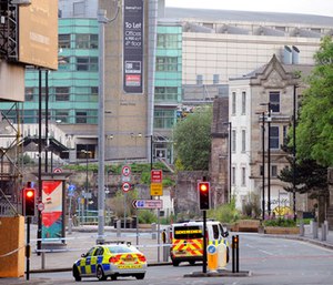Police block roads near to the Manchester Arena, seen at the right, in central Manchester, England. (AP Photo/Rui Vieira)