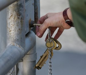 A CO uses a key to open a gate to an exercise yard on death row at San Quentin State Prison Tuesday, Aug. 16, 2016, in San Quentin, Calif.