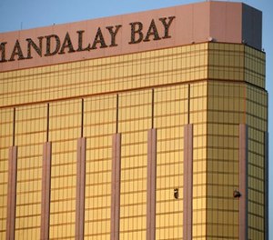 Drapes billow out of broken windows at the Mandalay Bay resort and casino Monday, Oct. 2, 2017, on the Las Vegas Strip following a deadly shooting at a music festival in Las Vegas. A gunman was found dead inside a hotel room.