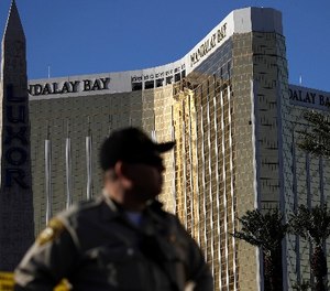 A Las Vegas police officer stands by a blocked off area near the Mandalay Bay casino, Tuesday, Oct. 3, 2017, in Las Vegas. Authorities said Stephen Craig Paddock broke windows on the casino and began firing with a cache of weapons, killing dozens and injuring hundreds at the festival.