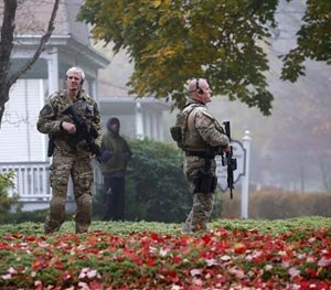 Pennsylvania State Police SWAT officers stand by as Eric Frein arrives at the Pike County Courthouse for his arraignment in Milford, Pa., Friday Oct. 31, 2014.