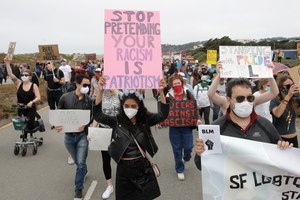 Sarzana Khan, center, and Gabriel Reyla, right, march with gay activists and supporters in San Francisco, Sunday, June 14, 2020, at a protest over the Memorial Day death of George Floyd. Image: AP Photo/Jeff Chiu