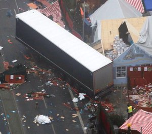 In this Dec. 20, 2016 file photo the trailer of a truck stands beside destroyed Christmas market huts in Berlin, Germany the day after a truck ran into a crowded Christmas market and killed several people.
