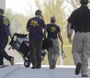 In this April 21, 2014, file photo, members of the FBI evidence response team enter the federal courthouse in Salt Lake City. (AP Image)