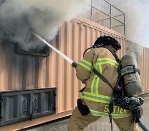 A firefighter engages in transitional attack training.