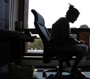 In this July 10, 2015, file photo a woman speaks to The Associated Press inside the police station in Gloucester, Mass.