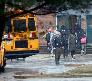Police move students into a different area of Great Mills High School, the scene of a shooting, Tuesday morning, March 20, 2018 in Great Mills, Md.