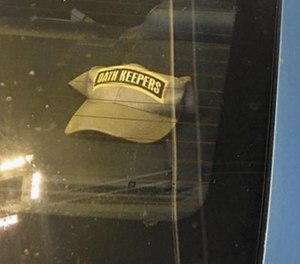 An Anne Arundel police officer has been suspended for displaying a hat bearing the name of a controversial group in the rear windshield of a police cruiser.