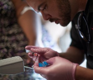 A MedStar community paramedic conducts a point-of-care test during a patient visit.