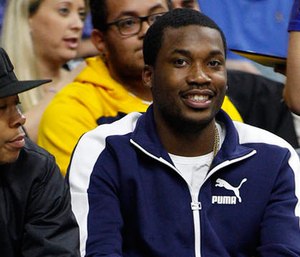 In this Wednesday, Feb. 3, 2016, photo, rapper Meek Mill looks on during the second half of an NBA basketball game between the Atlanta Hawks and the Philadelphia 76ers in Philadelphia.