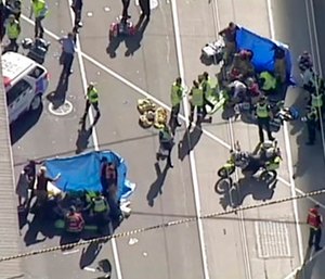 Emergency medical workers offer aid to victims struck by a vehicle in Melbourne, Australia. (Australian Broadcast Corp. via AP)