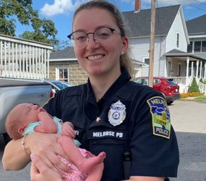 Melrose Police Officer Ashley Baldwin holds the baby she helped deliver on August 19, 2020.