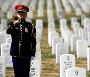 A lone U.S. Army bugler plays Taps at the conclusion of the First Annual Remembrance Ceremony in Dedication to Fallen Military Medical Personnel at Arlington National Cemetery, March 11, 2009.DoD photo by Mass Communication Specialist 1st Class Chad J. McNeeley