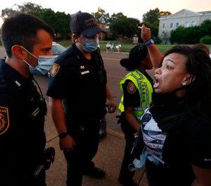 Theryn Bond confronts Memphis police officers during protests on Union Avenue Wednesday night, May 27, 2020, in Midtown Memphis.