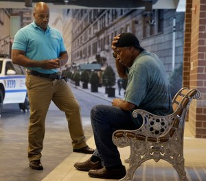 In this Sept. 2, 2015 file photo, New York City Police Officer Lamont Edwards talks to actor Nathan Purdee during a Crisis Intervention Training class at the New York Police Department Police Academy, in New York.
