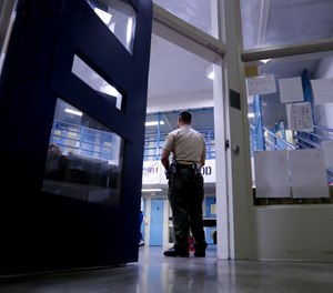 A CO watches inmates at the Twin Towers Correctional Facility in Los Angeles.