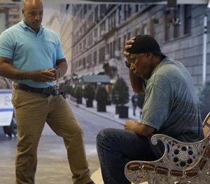 In this Wednesday, Sept. 2, 2015 photo, Officer Lamont Edwards talks to actor Nathan Purdee during a Crisis Intervention Training class at the New York Police Department Police Academy, in New York.