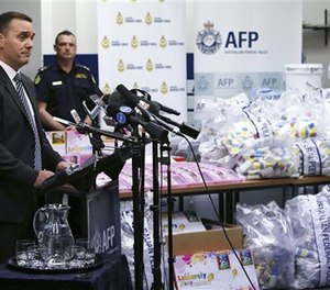 Commander Chris Sheehan from the Australian Federal Police stands by a display of confiscated drugs in Sydney, Monday, Jan. 15, 2016. (AP Image)
