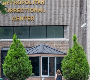 An employee checks a visitor outside the Metropolitan Correctional Center, Tuesday, Aug. 13, 2019 in New York. (AP Photo/Mary Altaffer)