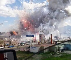 This image made from video recorded from a passing car shows an explosion ripping through the San Pablito fireworks' market in Tultepec, Mexico, Tuesday, Dec. 20, 2016. (Jose Luis Tolentino via AP)