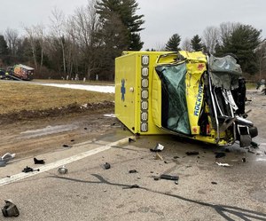 Two people in an SUV died Friday after a semi struck the vehicle from behind, pushing it into an ambulance.