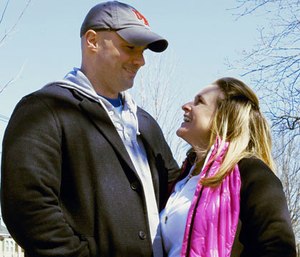 In this Tuesday, March 18, 2014 photo, Boston Marathon bombing survivor Roseann Sdoia stands with her boyfriend, Boston firefighter Mike Materia, after her doctor's appointment in Newton, Mass.