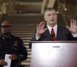 Dallas mayor Mike Rawlings, left , and Dallas police chief David Brown, right, during a news conference, Friday, July 8, 2016, in Dallas.