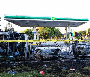 Burnt cars sit in the parking lot of a gas station that was destroyed during protests Aug. 14, 2016, following a fatal police-involved shooting the day before in Milwaukee, Wis. (Photo/Armando L. Sanchez/Chicago Tribune)