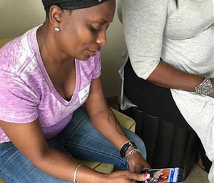 Mina Justice speaks to a reporter discussing texting with her son, Eddie Justice, who was in a bathroom during the mass shooting at the Pulse nightclub, in Orlando.