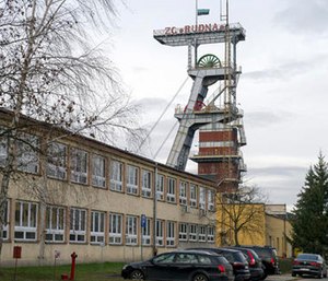 A view of the entrance to the Rudna copper mine with a miners flag at half-staff.