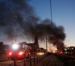 Fire burns during protests over the death of George Floyd, a black man who died in police custody.