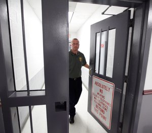 Mount Olive maximum security prison warden, David Ballard, walks out of the secure area at the prison in Mount Olive, W. Va.