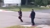 Video: Ranting barefoot man holding baby tries to steal patrol car