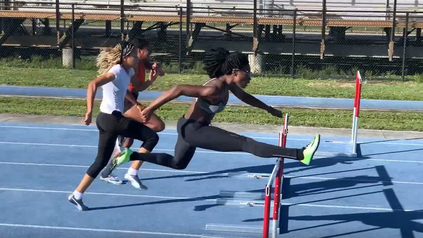 Officer Mulern Jean clears a hurdle during training.