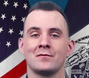 Brian Mulkeen was shot three times by his fellow officers as he grappled on the ground with an armed suspect.