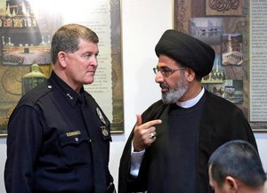Los Angeles Police Deputy Chief Michael Downing talks with Sayed Moustafa al-Qazwini, founding Imam of the Islamic Educational Center of Orange County at a news conference at the Islamic Center of Southern California in Los Angeles Monday, Nov. 28, 2016. (AP Photo/Nick Ut)