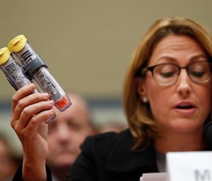 In this Wednesday, Sept. 21, 2016, file photo, Mylan CEO Heather Bresch holds up EpiPens while testifying on Capitol Hill in Washington, before the House Oversight Committee hearing on EpiPen price increases. (AP Photo/Pablo Martinez Monsivais, File)