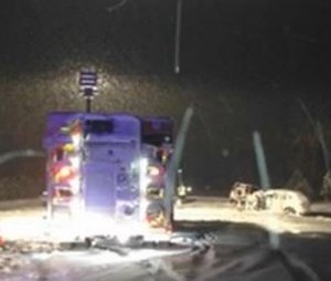 This image taken from a video of the crash scene shows an ambulance on its side after a head-on collision that seriously injured two EMTs.