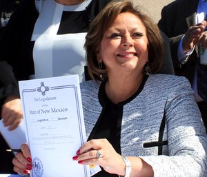 Gov. Susana Martinez holds signed legislation that expands access to the overdose antidote naloxone during a ceremony at a substance abuse treatment center for youth in Albuquerque, N.M. (AP Photo/Susan Montoya Bryan)