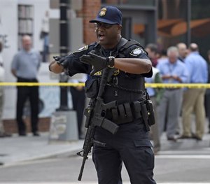 Police tell members of the media to move near the Washington Navy Yard in Washington, Thursday, July 2, 2015. (AP Image)